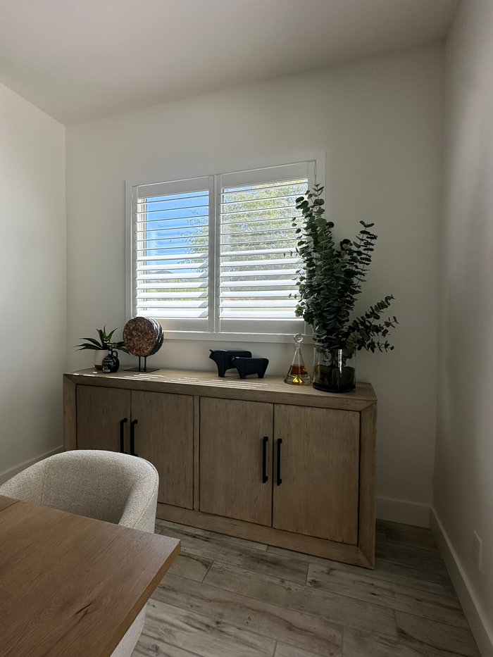 Dining room buffet below a white plantation-shuttered window, an interior we finished in the Phoenix, AZ metro