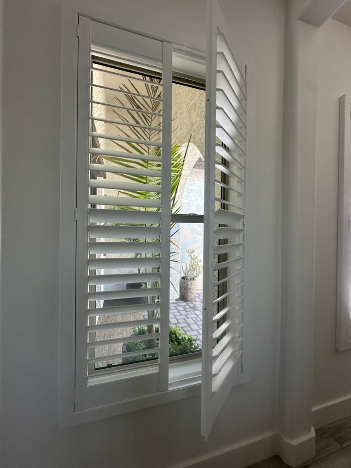 Norman shutter panel swung open on its hinge showing the tight, gap-free closure we specify for Cave Creek, AZ sun exposure