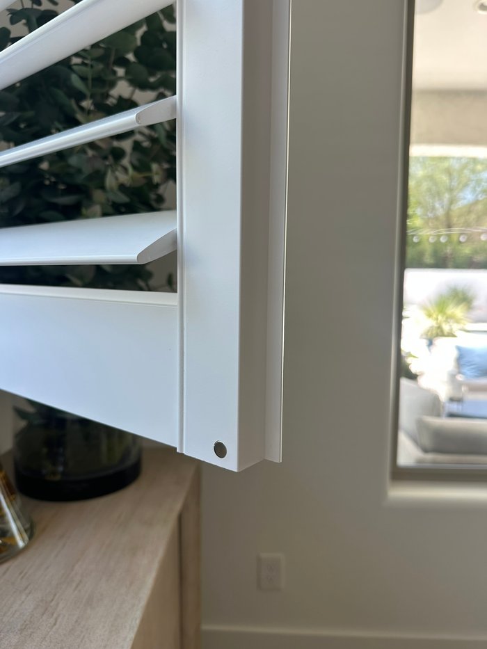 Close-up of the factory-cured finish on a Norman shutter louver and frame, the quality we install in Gilbert, AZ