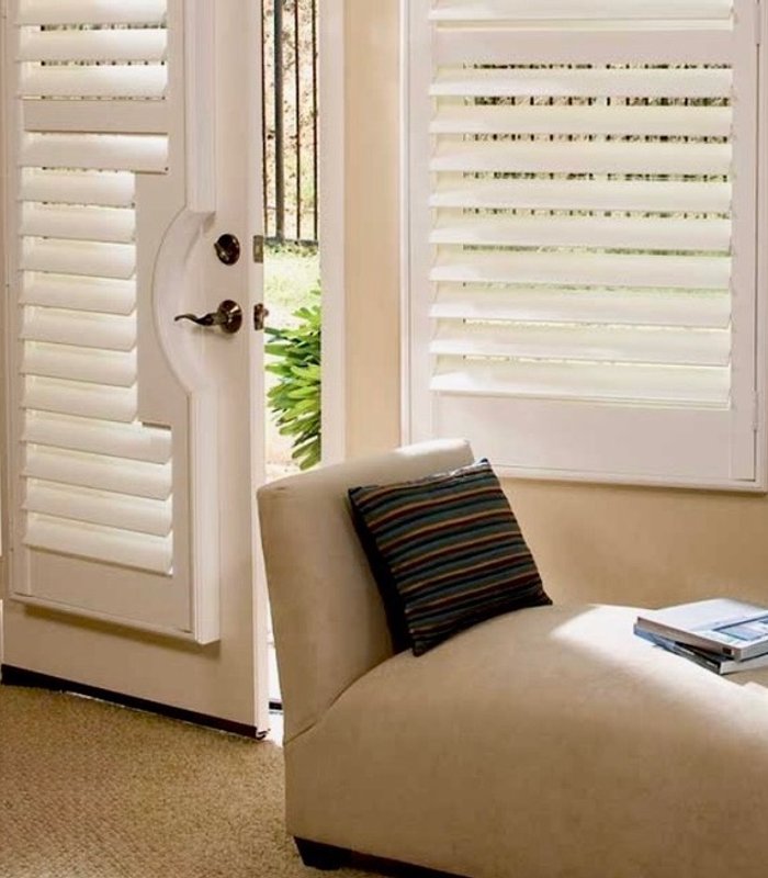 Norman shutters flanking a front entry door with a matching door panel