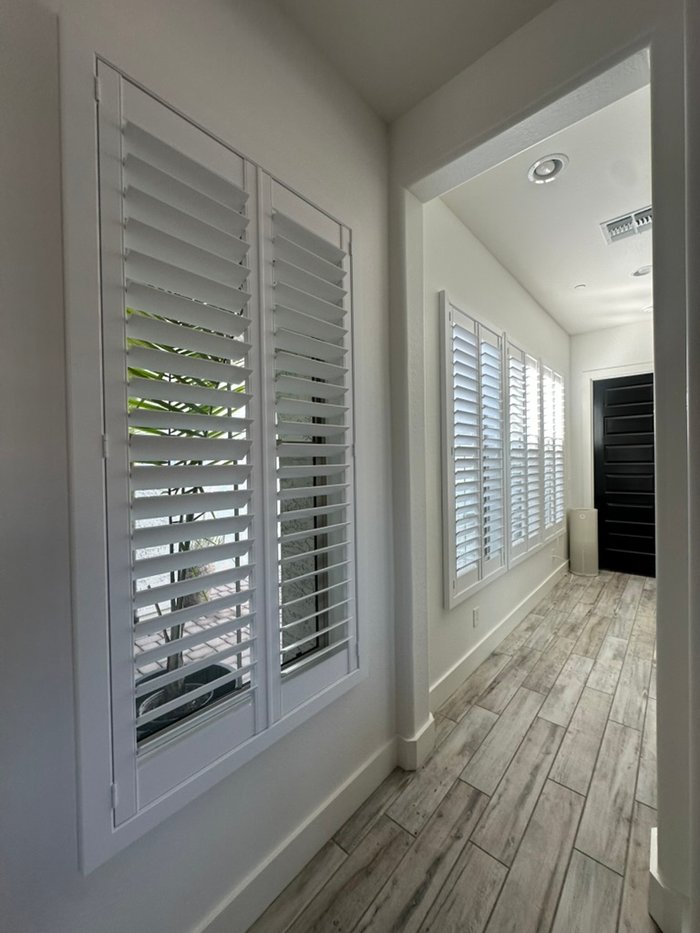 Hallway window shuttered in white with louvers open to garden greenery, Fountain Hills, AZ