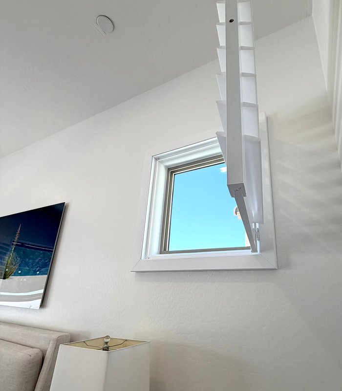 Custom-shaped high window shutter swung open to show the fitted frame