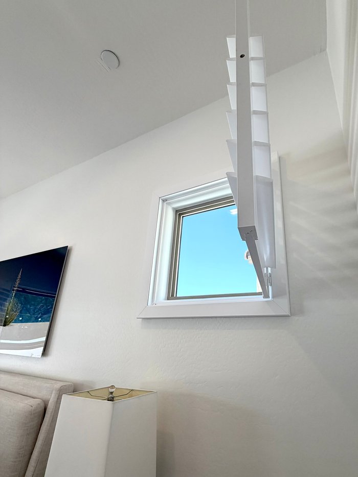 Custom-shaped high window shutter opened to show the fitted frame, built for Carefree, AZ view homes