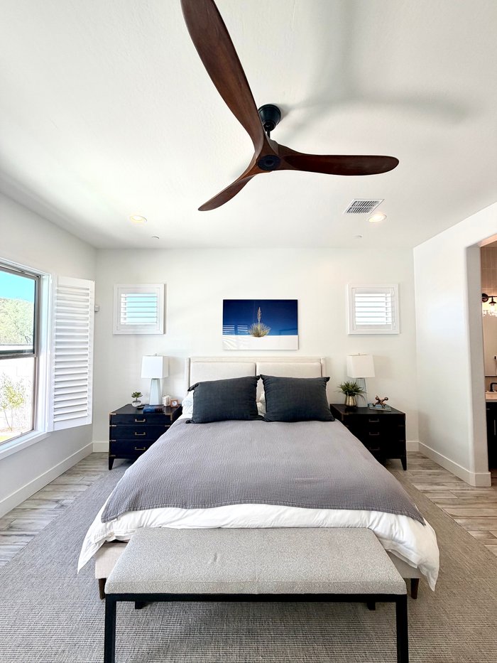 Matching white shutters on both bedroom windows, the consistent look we build across Mesa, AZ homes