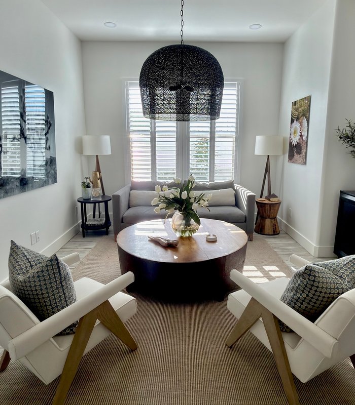 Vaulted living room with Norman shutters and a woven pendant light