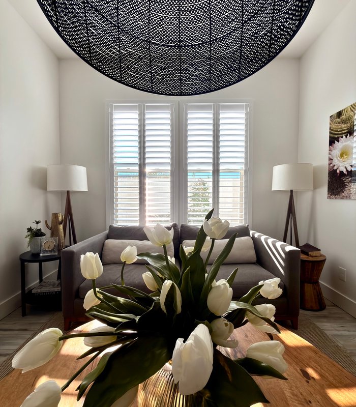 Sunlit sitting room with plantation shutters filtering Arizona afternoon light