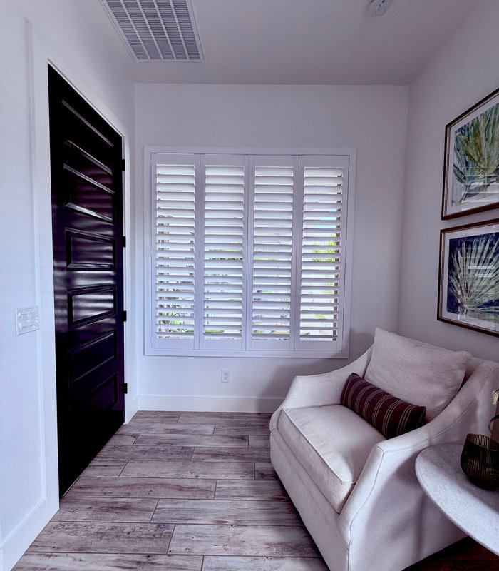 Entry sitting nook with a four-panel Norman shutter closed against the afternoon sun