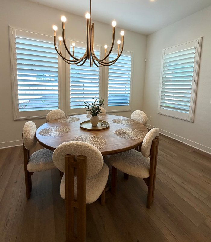 Breakfast nook framed by Norman shutters on the window bank and a matching side window