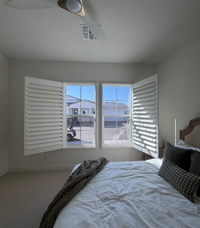 Bedroom corner window with Norman shutter panels folded fully back for an unobstructed view