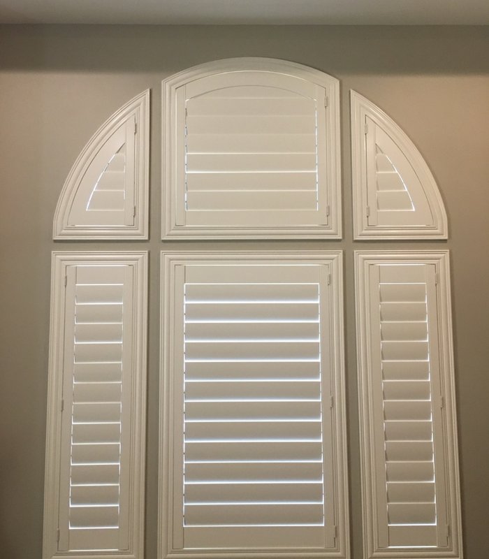 Custom arched Norman shutter with matching side panels built to the radius