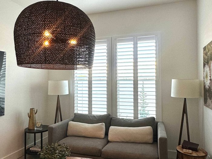 Family room with plantation shutters closed against the afternoon sun, how Chandler, AZ homeowners cut cooling load