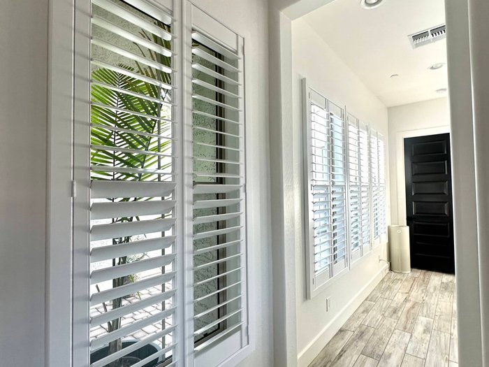 One finish and louver size carried down a hallway of windows, the consistent look Chandler, AZ open floor plans need