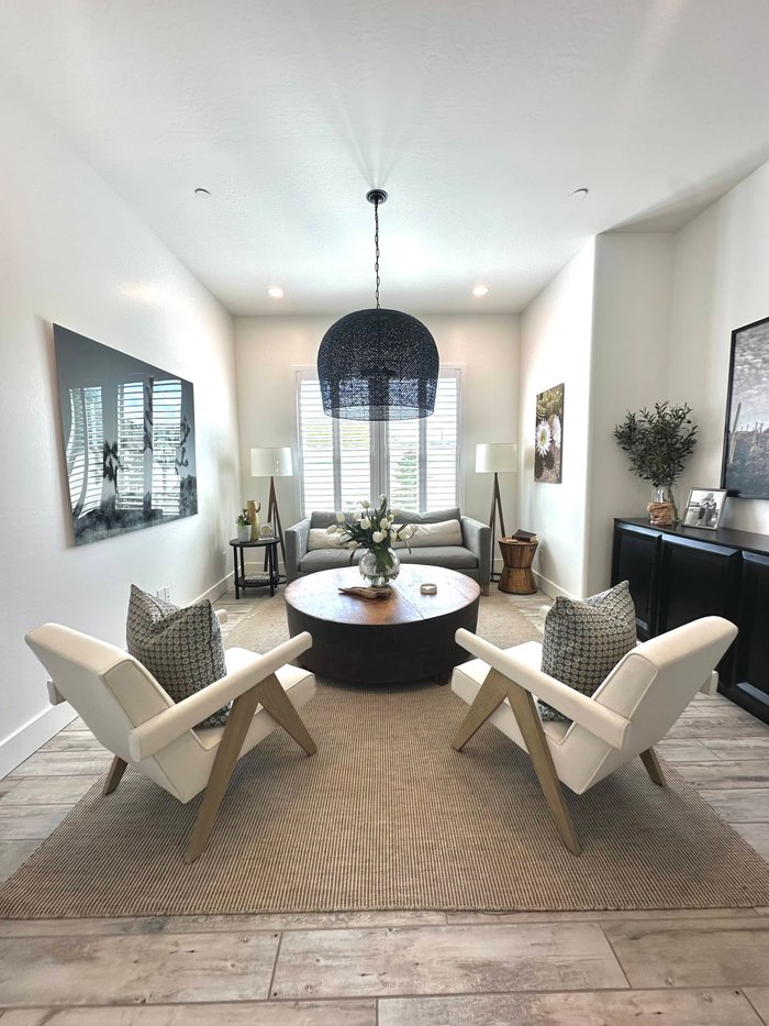 White plantation shutters on a tall picture window, an off-white finish that suits most Scottsdale, AZ HOA guidelines